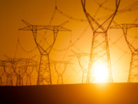 Silhouetted electricity pylon grid